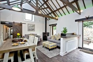 a living room with a table and a couch at The Barn in Lanhydrock, Bodmin in Bodmin