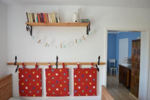 a room with two red curtains hanging on a wall at Dom Wakacyjny - Siedlisko Gutowo in Lidzbark