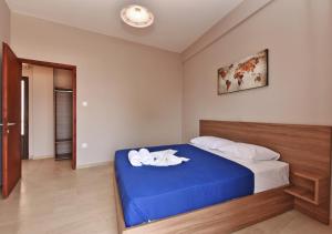 Postel nebo postele na pokoji v ubytování Alexandros SeaView Suites