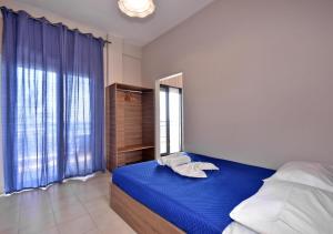Postel nebo postele na pokoji v ubytování Alexandros SeaView Suites