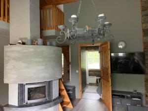 庫薩莫的住宿－Rukankuukkeli b13，客厅设有壁炉和吊灯。