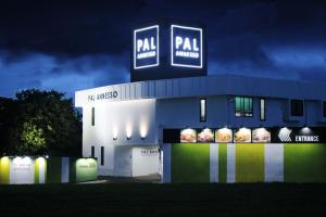 a building with a sign on top of it at night at Hotel Pal Anesso Nakatsu (Love Hotel) in Nakatsu