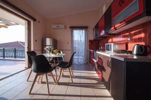 a kitchen with a table and chairs and a kitchen with a balcony at Cyrenia Guesthouse in Monemvasia