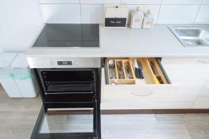 a kitchen with a stove top oven under a counter at Garden House in Ljubljana