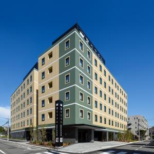 a building on a street with a blue sky at Henn na Hotel Tokyo Haneda in Tokyo