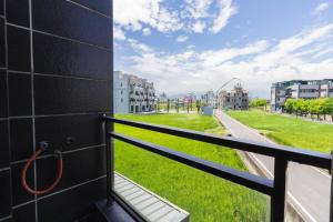 a balcony with a view of a green field at 曉翠軒親子民宿 in Wujie