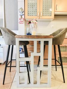 a kitchen table and two stools in a kitchen at Studio Nina in Umag