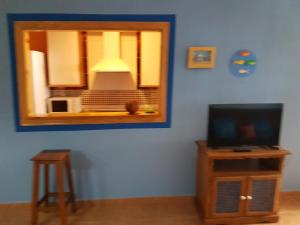 a living room with a mirror and a tv at Apartamentos Atlanterra COSTA Y SOL in Zahara de los Atunes