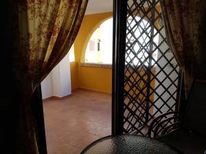 a view of a room with a table and a window at Apartamentos Atlanterra COSTA Y SOL in Zahara de los Atunes