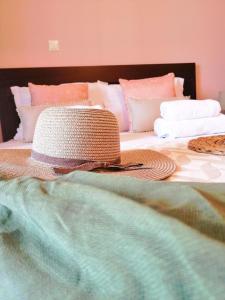 a hat sitting on top of a bed at Pension Anastasia in Ammouliani