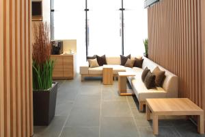a lobby with couches and tables in a room at Tokyu Stay Kamata - Tokyo Haneda in Tokyo