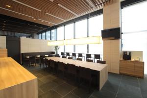 a dining room with a long table and chairs at Tokyu Stay Kamata - Tokyo Haneda in Tokyo
