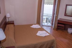 a bedroom with a bed with two towels on it at Istiaia Hotel Spa in Loutra Edipsou