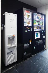 a soda machine and a drink cooler in a store at Tokyu Stay Kamata - Tokyo Haneda in Tokyo