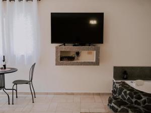 a living room with a flat screen tv on a wall at Kinneret View in Kinneret