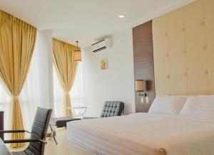 Postel nebo postele na pokoji v ubytování D'Hotel & Suites