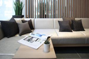 a living room with a couch with a magazine on a table at Tokyu Stay Kamata - Tokyo Haneda in Tokyo