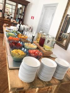 a table topped with plates and bowls of food at Sjöbo Gästgifvaregård in Sjöbo