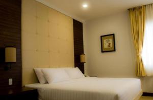 Postel nebo postele na pokoji v ubytování D'Hotel & Suites