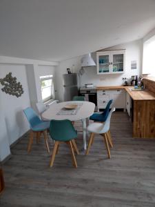 a kitchen with a table and chairs in a room at Gästehaus Twee Linden in Warnemünde +38 photos