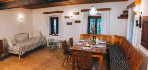 a living room with a table and a couch at Hiša na Pohorju in Šmartno na Pohorju