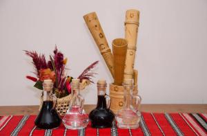 three bottles sitting on top of a table with bats at Casa Ursului in Vadu Moţilor