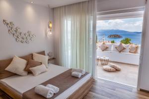 a bedroom with a bed and a view of the ocean at Elena's Tolo sea view in Tolo