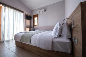 A bed or beds in a room at Cyrenia Guesthouse