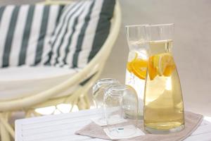 a glass vase with lemon slices on a table at Acroterra Rosa Luxury Suites & Spa in Akrotiri