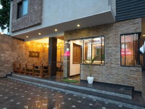 a facade of a house with a building at Hotel Gems Inn in Dehradun