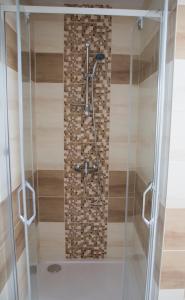 a bathroom with a shower with a glass door at Apartmán U Fuxů in Žleby