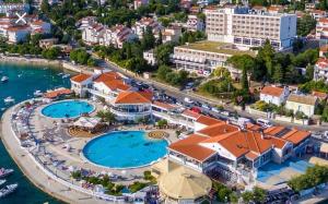 an aerial view of a resort with two pools at Sunset Apartment Selce in Selce