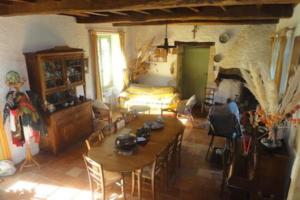 a living room with a table and a bed at Touvent maison au milieu des bois in Savignac-de-Miremont +17 photos