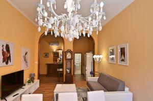 un salon avec un lustre dans l'établissement Appartamenti Pratello, à Bologne