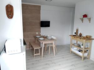 a kitchen with a table and chairs and a television at EL RINCON DE CRISTINA in Perlora
