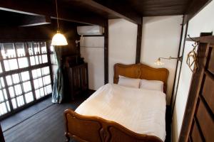 Een bed of bedden in een kamer bij Bed & Breakfast Tsukiya