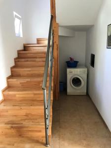 a staircase in a room with a washing machine at Aria Prive in Himare