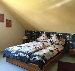 a bedroom with a large bed with a wooden headboard at Ferienwohnung Haus Andre _ fuer 4 in Ulmen