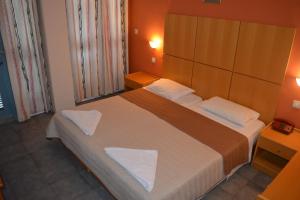 a hotel room with a bed and two nightstands at Achillion Hotel in Rhodes Town