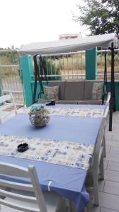 a blue table and chairs on a patio at Деси Къща за гости 1 in Chernomorets