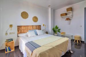 a bedroom with a large bed with a wooden headboard at ROOMQUEO-Only Adults in Barbate +20 photos