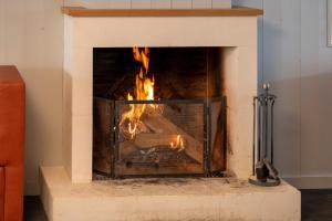 a fireplace with a fire in it at Thalacap Île de Ré - Thalasso & Spa in Ars-en-Ré
