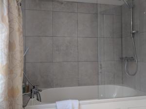 a bathroom with a bath tub with a shower at Trade Digs High Street in Stroud