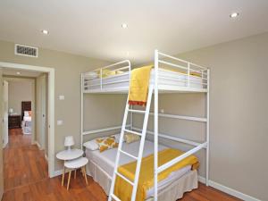 a bedroom with two bunk beds and a ladder at Del parque flats casa rincón del sol in Rincón de la Victoria