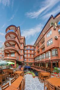 a hotel with tables and benches in front of a building at Hotel Access Nepal in Kathmandu