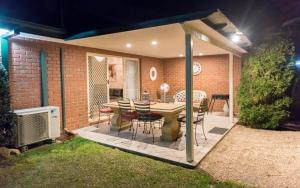 a patio with a table and chairs on it at The Birch House - Silver Birches Accommodation Bright in Bright