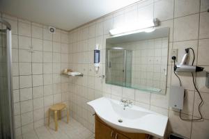 a bathroom with a sink and a mirror at Agerskov Kro & Hotel in Agerskov