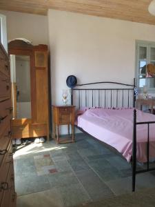 a bedroom with a bed and a dresser and a table at Οντας της Αθηνάς in Gialiskari