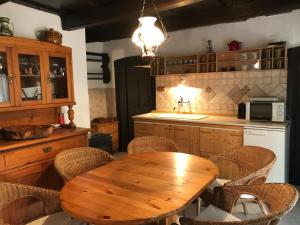 a kitchen with a wooden table and chairs at Island of peace in Badacsonytomaj