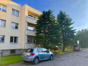 a car parked in a parking lot in front of a building at Wind Rose apartment in Kuressaare